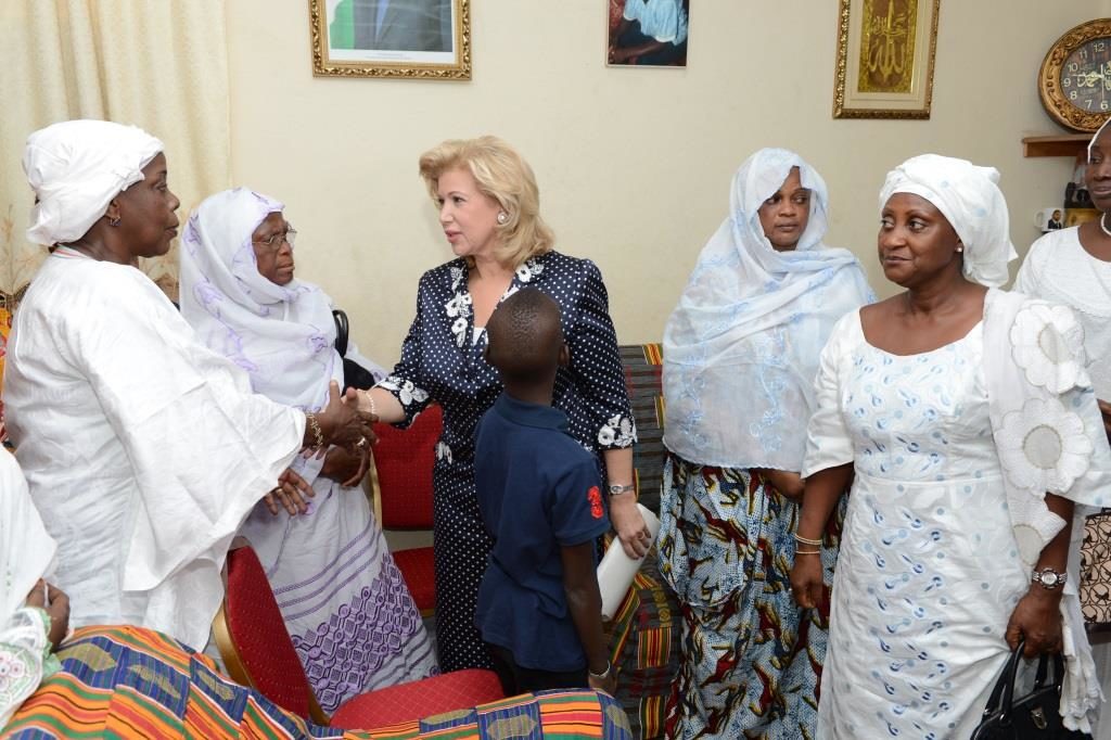 Mrs. Dominique Ouattara stands alongside Nimaga’s family
