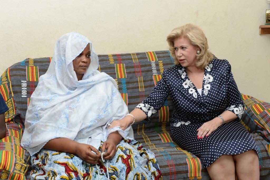 Mrs. Dominique Ouattara stands alongside Nimaga’s family